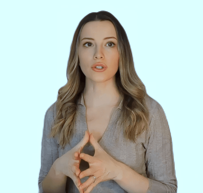 AI-generated avatar of a woman with long wavy brown hair wearing a light brown top, gesturing with her hands, on a light blue background.